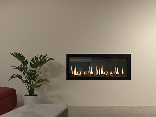 Vesta LCD fireplace next to pot plant with beige wall background